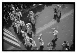 People walking in a rainy parade