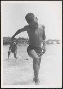 Ronald Monroe playing in the surf at the beach