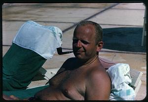 Man smoking a pipe by the pool, Eden Roc Hotel, Miami Beach, Florida