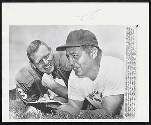 New Eagle Coach With Quarterback--Nick Skorich, right, new head coach of the National Football League's champion Philadelphia Eagles, poses with his number one quarterback, Sonny Jurgensen, during camera day at the Eagles training camp in Hershey. Skorich succeeds Buck Shaw who retired.