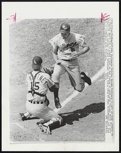 Baltimore Orioles Brooks Robinson is safe at home, coming in on Charley Lau's fly to right field in 2nd inning of game with Chicago White Sox here 8/22/ White Sox catcher Gerald NcNertney takes throw from RF Mike Hershberger, but lost ball in collision with Robinson.