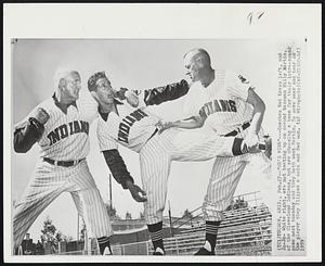 "He's Mine"---Coaches Red Kress left, and Jo-Jo- White right, are not beating up on second baseman Billy Martin, of the Cleveland Indians, but are choosing a team for their intra-squad game next Tuesday and they both want Martin. To save wear and tear on the player they flipped a coin and Red won.