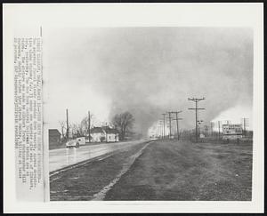 Elkhart, Ind. – Twin Death Clouds Approaching – Two separate funnel clouds reaching down to earth, spread devastation along highway U.S. 33 about one quarter mile east of Elkhart, In., yesterday. The New York Central Railroad tracks are at right. The picture was made by Elkhart Truth photographer Bill Borneman, shortly before they struck Dunlap, killing at least 22 persons.