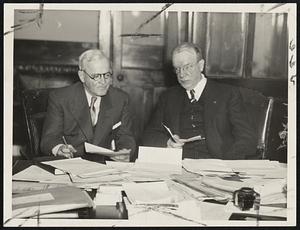 Only one hour at City Hall this morning and Mayor Mansfield's desk was covered with work. He is shown about to tackle it with this secretary, Joseph F. Mellyn. South Boston Liqour License Refused on Priests' Protest