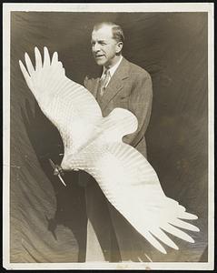 A New Bird-Like Note in Aviation. An aluminium wind tunnel model of a strange bird-like airplane completed at Los Angeles, Calif., where its developers expect it to mark a new step forward in aerial navigation. The peculiar design of the new model is expected to cause it to duplicate the "thrust" of the real bird's feathers which enable them to sail directly into the wind without effort. Photo shows John M. Walters with the new model. In the full size airplane the "feathers" effect will be given it by stamped pieces of metal overlapping like the feathers themselves do on a bird.