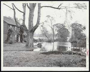 A Pretty Scene in Wayland is marred by the rising of flood waters and the wreckage left by two hurricanes. The house is located at Tansy's Corner.