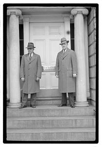Two men standing in front of a door with a sign, "City of Boston Park Department"