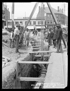 Distribution Department, Northern High Service Pipe Line, Section 14, laying 30-inch pipe in Malden Square, station 39, from the south, Malden, Mass., Apr. 22, 1897