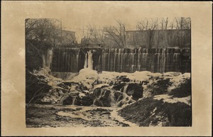 View of a dam, with water cascading over rocks