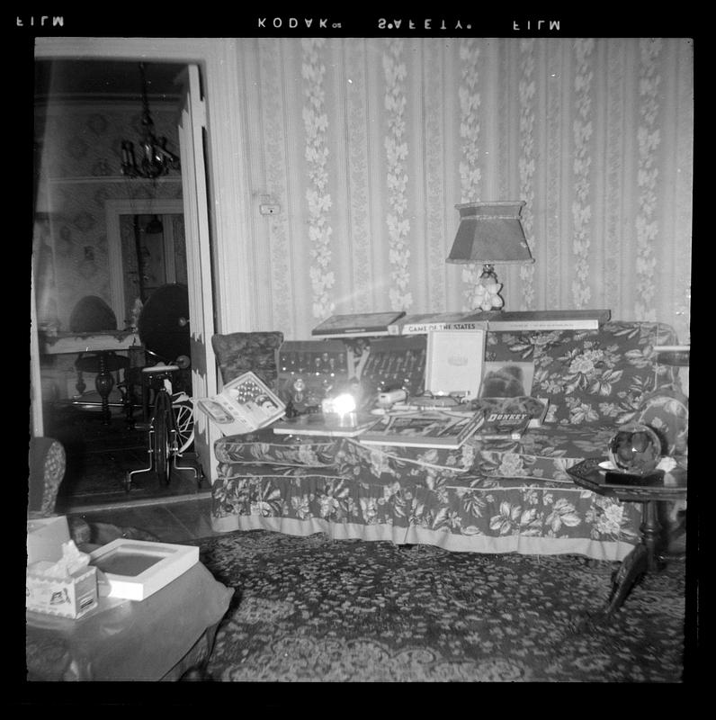 A floral pattern sofa with opened Christmas presents on it