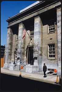 Front of stone building with American flag