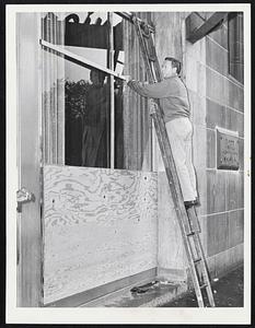 Not Much Time Left--Cy Greenberg, chief engineer at Boston's Hotel Touraine, is shown boarding up one of the hotel's windows.