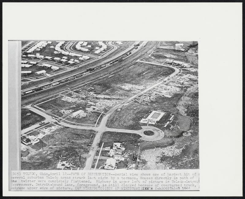 Toledo, Ohio - Path Of Destruction - Aerial view shows one of hardest hit of several suburban Toledo areas struck last night by a tornedo. Houses directly in path of the twister were completely flattened. Highway in upper left of picture in Toledo-Detroit Expressway. Detroit-bound lane, foreground, is still clogged because of overturned truck, extreme upper edge of picture.