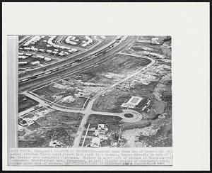 Toledo, Ohio - Path Of Destruction - Aerial view shows one of hardest hit of several suburban Toledo areas struck last night by a tornedo. Houses directly in path of the twister were completely flattened. Highway in upper left of picture in Toledo-Detroit Expressway. Detroit-bound lane, foreground, is still clogged because of overturned truck, extreme upper edge of picture.