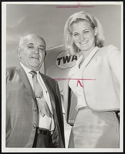S. C. Adams of the famous Allenhurst Restaurant, Danvers, departs for a combined business and pleasure world tour. With him is TWA stewardess Arlenne Doty as he enplaned at Logan Airport.
