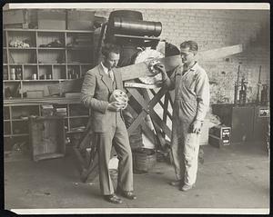 Kenneth W. Barkman (left) and N.E. Cherdavoine of Los Angeles are shown with their new airplane motor, a semi-turbine rotary, with no reciprocating parts. It is pistonless, valveless, sleeveless, calmless, has no springs, will develop 450 horsepower. has but 15 parts and consists of two housings. It weighs 220 pounds and is approximately 18 by 18 by 12 inches.