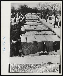 Awaiting Burial--Snow covered coffins rest in open receiving vault at Calvary Cemetery, Queens, as strike of union gravediggers ahd delayed more than 600 burials. Today Francis Cardinal Spellman led a group of 100 seminarians to the burial ground to inter the bodies. Pickets remained at their posts as the volunteers dug 90 graves. The cemetery, largest Roman Catholic burial ground in the area, is operated by trustees of New York City's St. Patrick's Cathedral.