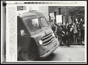 Prison Van Brings 'Chicago 7' to Hear Verdict--Group of pickets waves as a prison van enters Federal Building here today bringing seven defendants in the trial of conspiracy to riot to hear verdict today. Five were found guilty of inciting to riot, but seven were acquitted of charges of conspiracy.