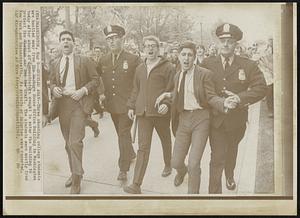 Hustles Away--Three shouting college students are hustled away from the Rayburn House Office Building in Washington today after about 40 demonstrators sought to enter the building to protest the Vietnam war and the draft. The students were mostly from New York and Massachusetts. No arrests or injuries were reported.