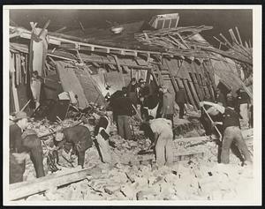 Searchers Recover Quake Dead Working Desperately, Searchers are Shown Recovering Dead From the Wreckage of the Stockwell Building in Compton, Calif., Shaken by the Earthquake March 10. Before Midnight, Three Bodies Had Been Taken From the Ruins.