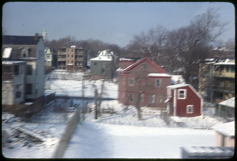 Snow covered ground and houses