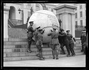 People including Alvan T. Fuller supporting a giant baseball printed with the words "Citizen Military Training Camps" on the steps of the Massachusetts State House