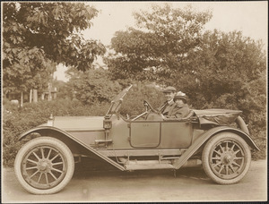 Man and woman in open two door automobile