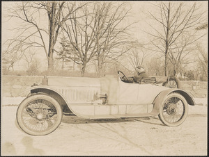 Man in open two door automobile
