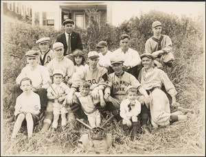 Baseball players posing with children