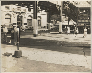 Street scene with supermarket and elevated railroad station in background