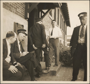 Street railroad employees sitting and standing