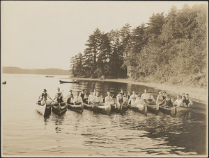 Group of people posing in 10 canoes