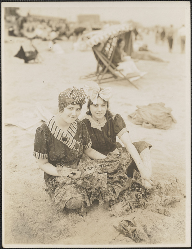 Two women with headscarves on beach