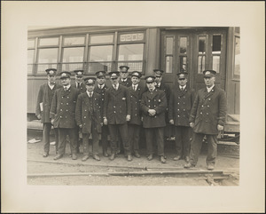 Twelve street railway employees in front of streetcar