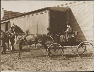Miss Alice Sargent in Larz Anderson horse and buggy, Miss Dorothy Forbes looks on, Brookline Riding School
