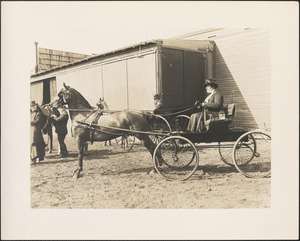 Miss Alice Sargent in Larz Anderson horse and buggy, Miss Dorothy Forbes looks on, Brookline Riding School