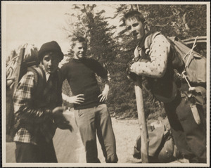 Three men with hiking gear outdoors