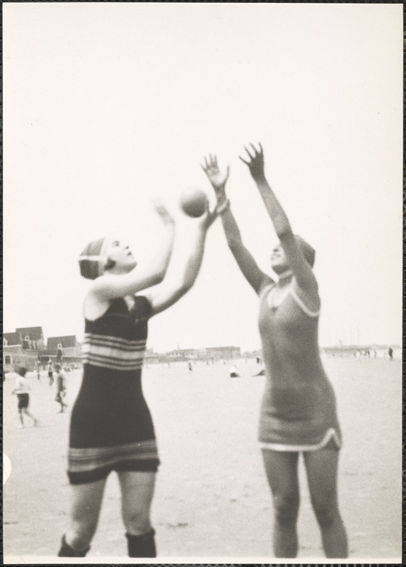 Two women playing with a ball on a beach