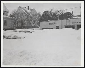 Hope There's Antifreeze in the radiators of these cars parked in a used car lot on North Beacon St., Watertown. The proprietor of the lot has plenty of spadework to do before he can show his autos.