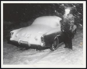 Navy Man Robert Ball of Hudson Falls, N.Y., waves for help early today after becoming stuck on snow-clogged Charles St.