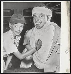 Chicago Cubs pitcher Paul Minner and 10-year-old Robert Robek pull a switch. Instead of the big leaguer giving out with the autograph, he collects the youngster’s on the expanse of the cast. Minner injured his spine a month ago and will be out the remainder of the season.