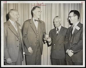 Presidential Aide Gets Medal - Presidential assistant Sherman Adams gets the silver medal of the National Association of Cotton Manufacturers at their centennial meeting from Massachusetts Governor Herter. Left to right at ceremony: Seabury Stanton of New Bedford, general chairman of the committee, Gov. Herter, Adams, and William F. Sullivan of Belmont, re-elected president of the association.