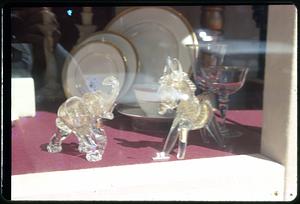 Glass elephant and horse in store window