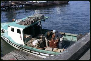 Fishermen with catch on boat