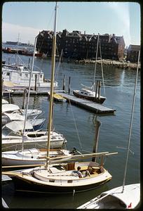 Docked boats, brick buildings in background