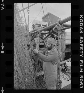 Fisherman fixing a net