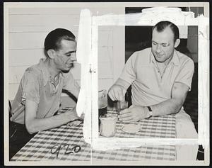 This picture shows the adhesive tape on Jack Sharkey's left eyebrow and eyelid, hiding a wound inflicted by a sparring partner at Sharkey's training camp in Orangeburgh, N. Y. Jack doesn't look worried as he stirs a glass of iced tea and ponders over next Tuesday's fight with the Brown Bomber, but Louis may select that eye as a target early in the battle.