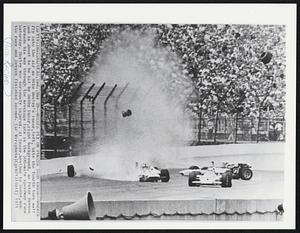 Wheels Fly on Fourth Turn Crash--Wheels fly into the air as Mike Mosley’s racer,left, hits the fourth turn wall and is about to be hit by Bobby Unser,right background, as Peter Revson threads his way through the wreckage late in the 500-mile speedway race Saturday. Mosley was seriously injured. Al Unser,brother to Bobby,won the race and Revson finished second.