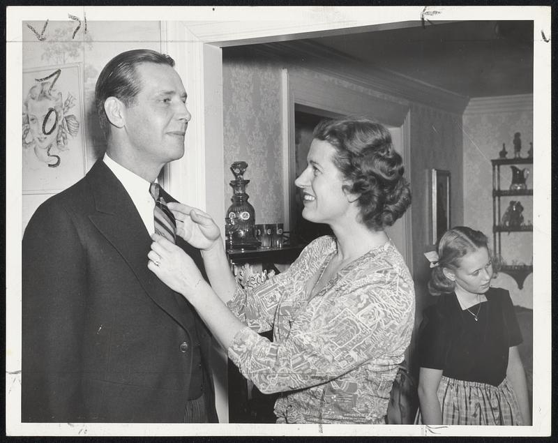The Final Touch-Mrs. Maurice Tobin straightens her husband's tie just before leaving for his inauguration as Governor.