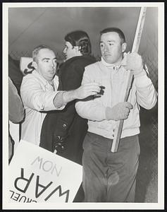 Fort Devens. Unidentified man, claims to be ex G.I., tears down pacifists signs